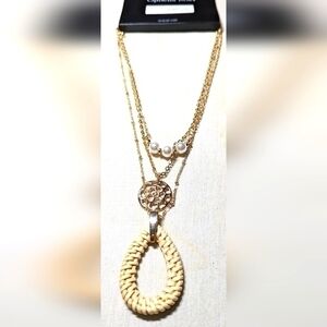 An Ophelia Roe triple strand necklace in Rose gold hue. NWT.